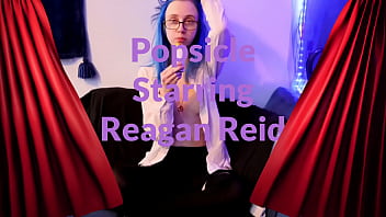 Emo punk girl sucks on a popsicle