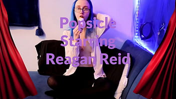 Emo punk girl sucks on a popsicle