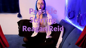 Emo punk girl sucks on a popsicle