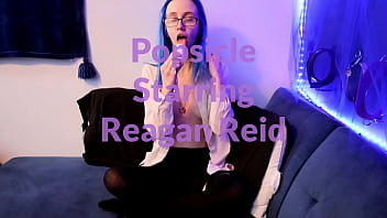 Emo punk girl sucks on a popsicle