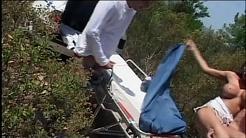 The two doctors fuck the busty patient in the middle of the countryside