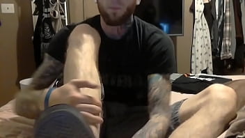 Tattooed man smelly socks