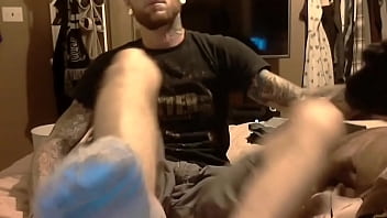 Tattooed man smelly socks