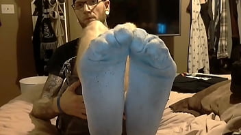 Tattooed man smelly socks