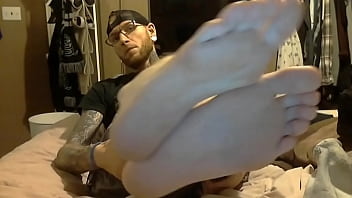 Tattooed man smelly socks