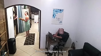 While the husband works the wife in a towel greets the delivery man While the husband works the wife in a towel greets the delivery man