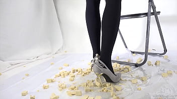 Beautiful legs woman slams food with legs