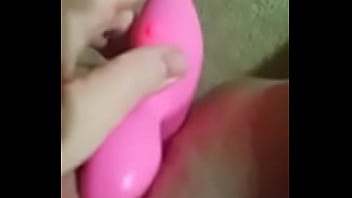 Blonde girl uses a dildo