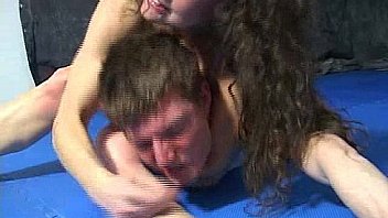 Mistress in bikini defeats man by scissorhold in a fight