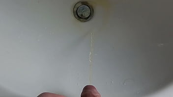 Boy is pissing in the sink and makes stinky farts