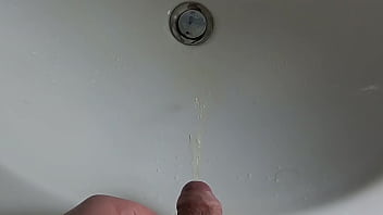 Boy is pissing in the sink and makes stinky farts
