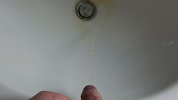 Boy is pissing in the sink and makes stinky farts