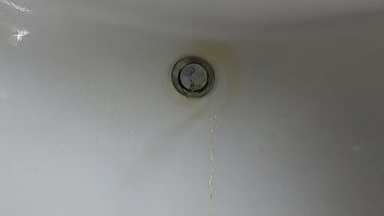 Boy is pissing in the sink and makes stinky farts