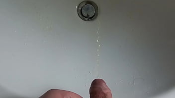 Boy is pissing in the sink and makes stinky farts
