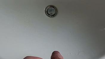 Boy is pissing in the sink and makes stinky farts