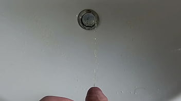 Boy is pissing in the sink and makes stinky farts