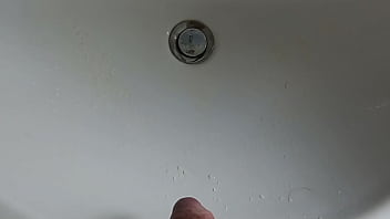 Boy is pissing in the sink and makes stinky farts