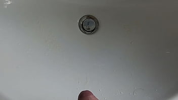 Boy is pissing in the sink and makes stinky farts