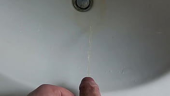 Boy is pissing in the sink and makes stinky farts