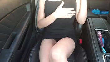 Callie may in black dress uses a toy inside a car while in public