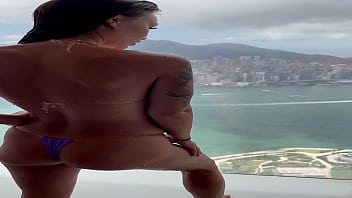 Monika fox in purple bikini swims in pool & poses by window against background of city free