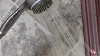 Shy redhead and a shower head