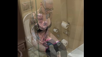 Busty girl watches porn and jerks off on the toilet peeping