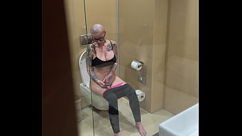 Busty girl watches porn and jerks off on the toilet peeping