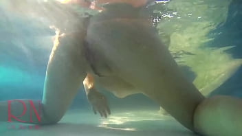 Elegant and flexible babe swimming underwater in the outdoor swimming pool Elegant and flexible babe swimming underwater in the outdoor swimming pool