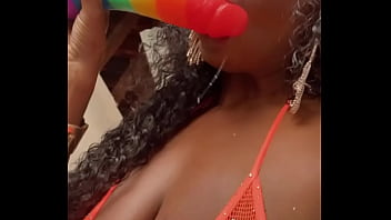 Wet lips licking a thick dildo