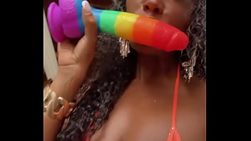 Wet lips licking a thick dildo