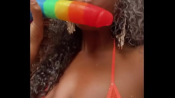 Wet lips licking a thick dildo