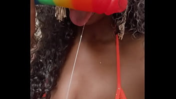 Wet lips licking a thick dildo