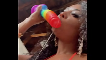 Wet lips licking a thick dildo