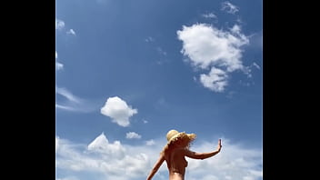 Sexy stepmother walks naked in the field