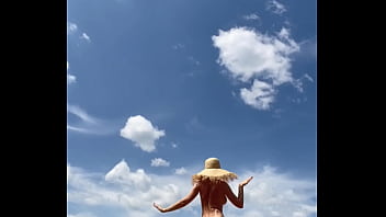 Sexy stepmother walks naked in the field