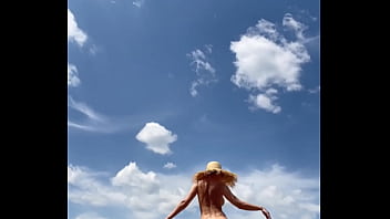 Sexy stepmother walks naked in the field