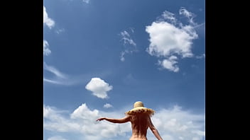 Sexy stepmother walks naked in the field