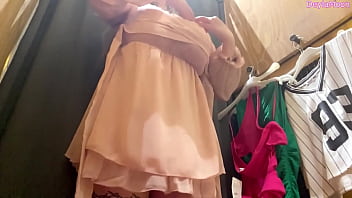 Beautiful stepmother changing clothes in a clothing store shooting in the dressing room
