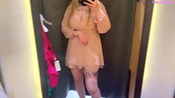 Beautiful stepmother changing clothes in a clothing store shooting in the dressing room Beautiful stepmother changing clothes in a clothing store shooting in the dressing room