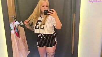 Beautiful stepmother changing clothes in a clothing store shooting in the dressing room