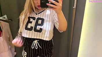 Beautiful stepmother changing clothes in a clothing store shooting in the dressing room