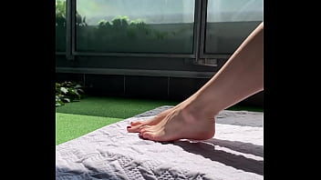 Wife teases a friend on the terrace wth her huge feet