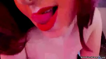 Redhead amateur shemale camgirl with nice pair of tits wanks and rubs big dick in bed while she is wearing only black stockings on webcam