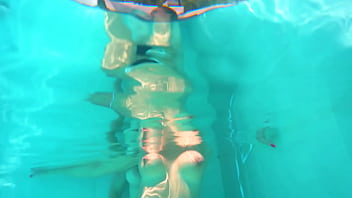 Underwater lesbian strap on sex