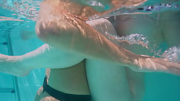 Underwater lesbian strap on sex