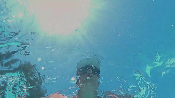 Underwater lesbian strap on sex