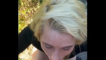 Blonde streetwalker takes a facial in public