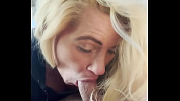 Blonde streetwalker takes a facial in public