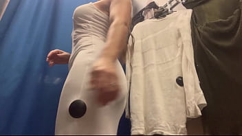 A woman with big boobs in a public fitting room